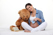 beautiful pregnant woman holding a teddy bear