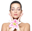 Beauty face of pretty woman with flower. Beauty treatment concep