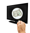 Photo: dollars bank note and hand holding magnificent lens glass dollars bank note and hand holding magnificent lens glass