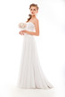Beautiful woman with bunch of flowers, white wedding dress