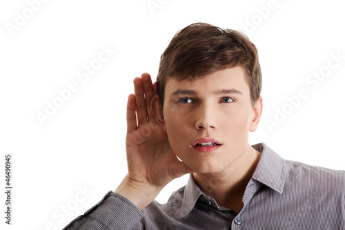 Photo: Young caucasian businessman listening gossip Young caucasian businessman listening gossip