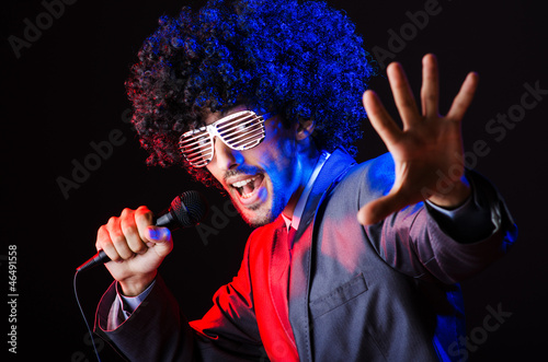 Photo: Young singer in afro wig singing at disco Young singer in afro wig singing at disco