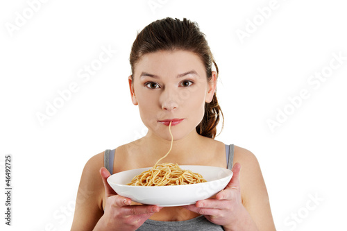 Photo: Young beautiful woman eating spaghetti Young beautiful woman eating spaghetti
