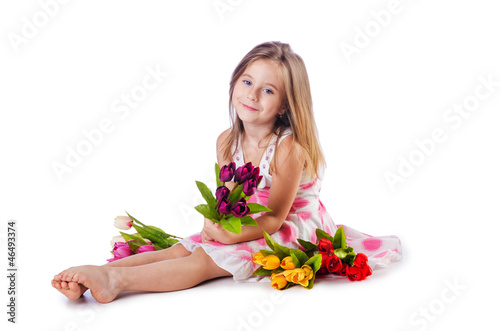 Photo: Cute little girl with flowers on white Cute little girl with flowers on white