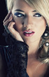 Close up portrait of a blond woman on black background