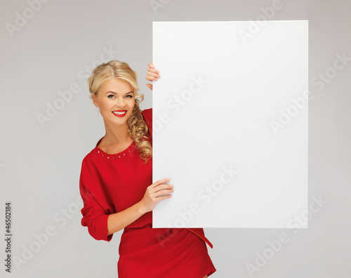 Photo: lovely woman in red dress with blank board lovely woman in red dress with blank board