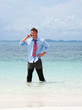 Business man calling by cell phone on the beach