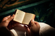 Young woman reading the Koran at the mosque