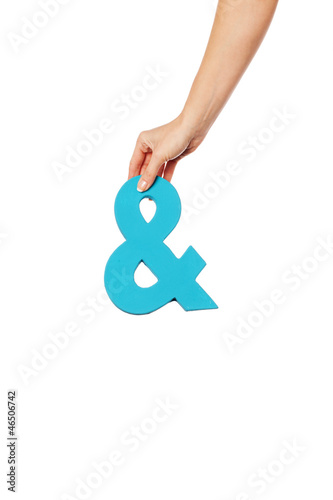 Photo: hand holding up an ampersand from the top hand holding up an ampersand from the top