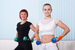 two fitness women with hand weights