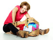 Pretty woman packs her overcrowded bag for holidays