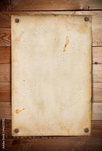 Photo: Old paper on the wood background Old paper on the wood background