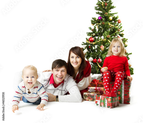 Photo: Christmas family and fir tree with gift boxes Christmas family and fir tree with gift boxes