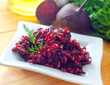 Fresh salad with beet and walnuts on white plate