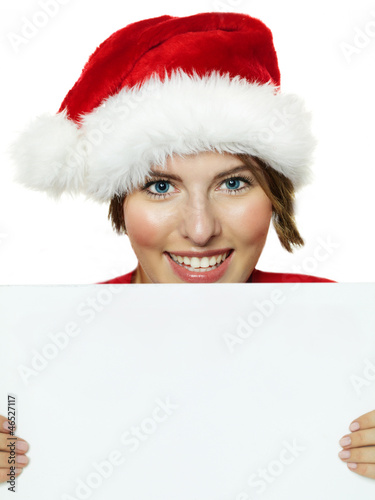 Photo: Women with santa hat presenting white message board Women with santa hat presenting white message board