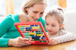 Mother and daughter with abacus