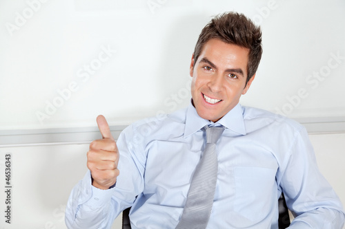 Photo: Young Businessman Gesturing Thumbs Up Young Businessman Gesturing Thumbs Up