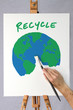 Artist painting a picture of the earth on a canvas