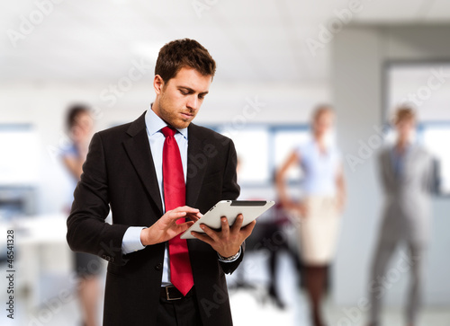 Photo: Businessman using his tablet Businessman using his tablet