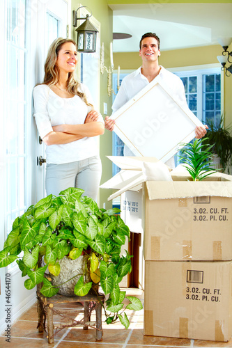 Photo: Happy couple moving in a new house. Happy couple moving in a new house.