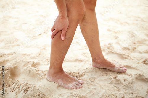 Photo: Woman legs with cramp. Woman legs with cramp.