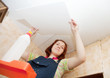 Girl glues ceiling tile