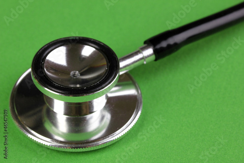 Photo: Stethoscope close-up on green background Stethoscope close-up on green background
