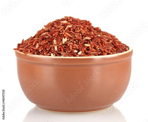 Photo: red rice in a brown plate , isolated on white red rice in a brown plate , isolated on white