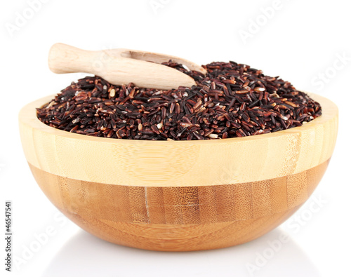 Photo: black rice in a brown wooden plat with a wooden scoop, black rice in a brown wooden plat with a wooden scoop,
