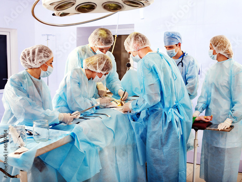 Photo: Surgeon at work in operating room. Surgeon at work in operating room.