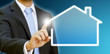 Businessman drawing his house with his finger