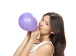 Young happy girl blowing balloons for birthday party