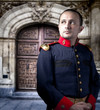 Antique soldier, man with military costume palace at background