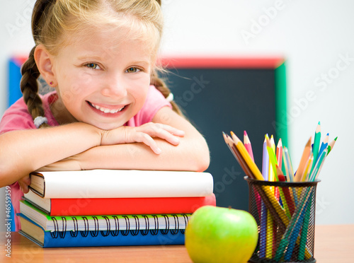 Photo: smart girl at workplace with the books smart girl at workplace with the books