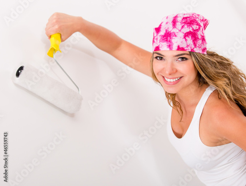 Photo: Woman painting a wall Woman painting a wall