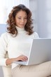 Young woman working on laptop at home