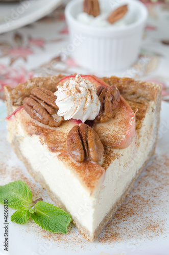 Photo: slice of cheesecake with apples and caramelized pecans closeup s slice of cheesecake with apples and caramelized pecans closeup s