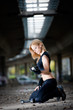 Woman lifting weights in urban setting