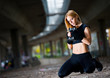 Woman lifting weights in urban setting