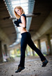 Woman lifting weights in urban setting
