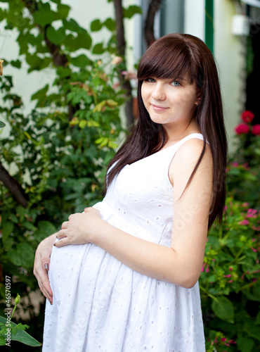 Photo: portrait of pretty young woman expecting a baby,outdoors, portrait of pretty young woman expecting a baby,outdoors,