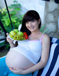 Photo: portrait of pretty young woman expecting a baby,outdoors, portrait of pretty young woman expecting a baby,outdoors,
