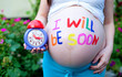 Photo: portrait of pretty young woman expecting a baby,outdoors, portrait of pretty young woman expecting a baby,outdoors,