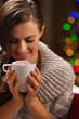 Happy woman holding cup of hot chocolate with marshmallows