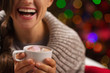 Closeup on chocolate with marshmallows in hand of happy woman