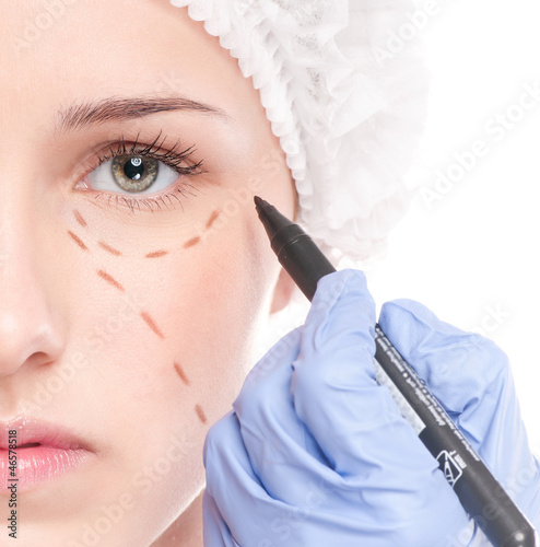 Photo: Beautician draw correction lines on woman face Beautician draw correction lines on woman face
