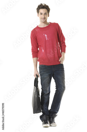Photo: young attractive man carrying handbag walking towards, young attractive man carrying handbag walking towards,