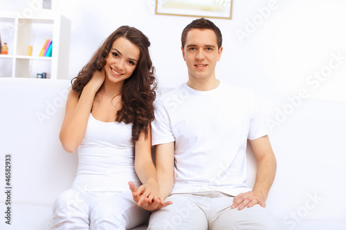 Photo: Young happy couple at hone together s Young happy couple at hone together s