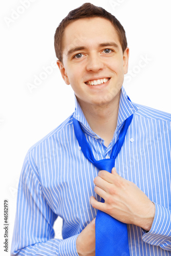 Photo: Businessman at home making his tie Businessman at home making his tie
