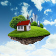 A piece of land in the air with house and tree.